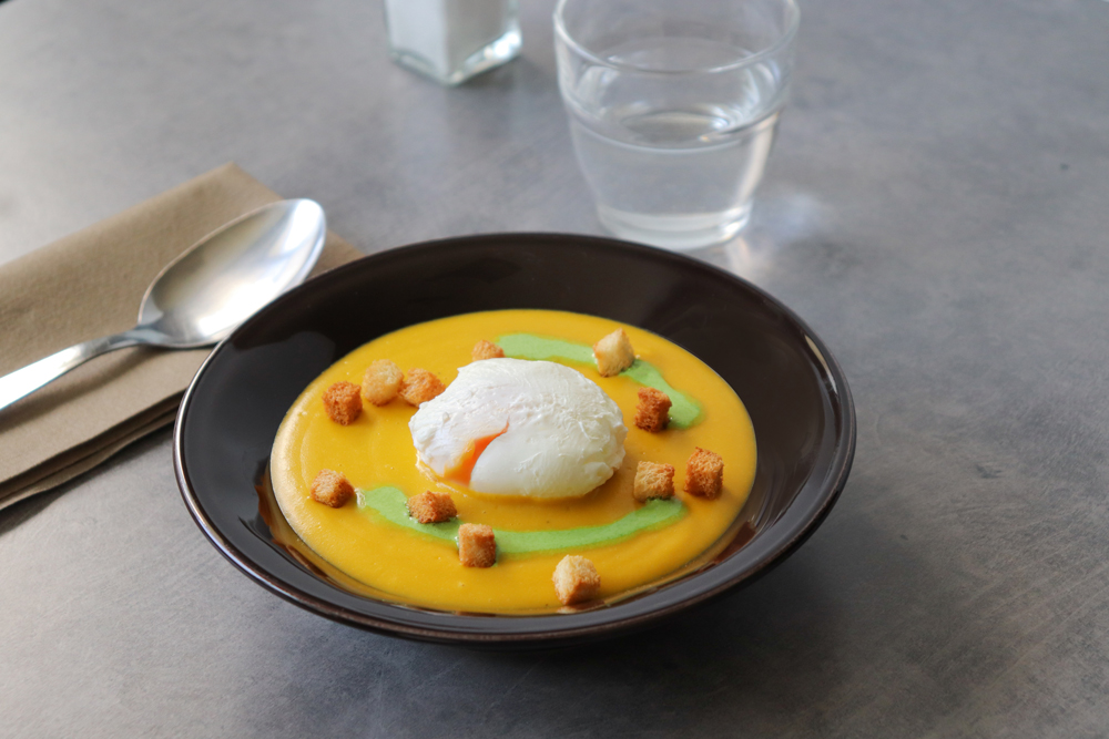 Velouté de carottes et pois cassés, oeuf poché et coulis d’herbes